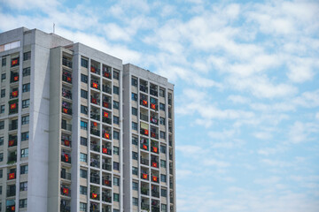 Modern apartment building with a lot of Vietnamese flags hanging on windows during importance special days in Hanoi, Vietnam