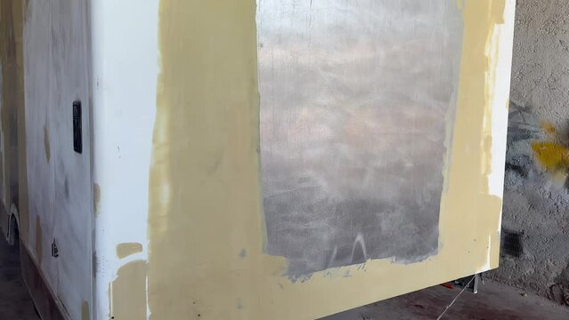 A van that has been puttied, surface defects removed and prepared for industrial painting