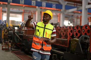 Engineer inspects and inspects shop at steel role material warehouse Smart industrial workers...