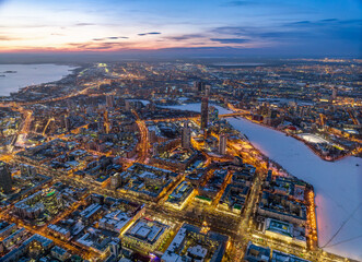 Fototapeta na wymiar Embankment of the central pond and Plotinka in Yekaterinburg at winter sunset. The historic center of the city of Yekaterinburg, Russia, Aerial View