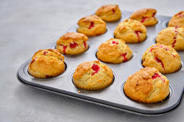 Muffins with red currants in the form for baking