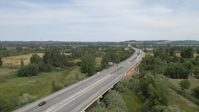 Aerial view of the A1 in Coimbra portugal, this is the most important highway in portugal as it connects Lisbon to Porto. Drone moving forward showing some cars and lorry&rsquo;s travelling.
