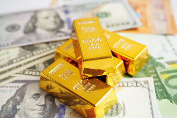 Gold bars with US dollar and Euro banknote money, finance trading investment business currency...