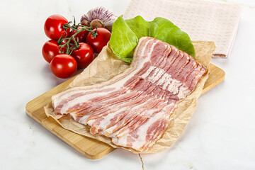 Sliced pork bacon oved board