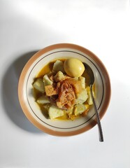a plate of lontong opor and sambal