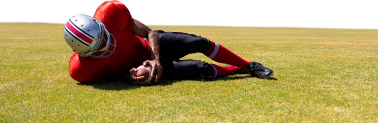 Digital png photo of american football player lying on sports field on transparent background