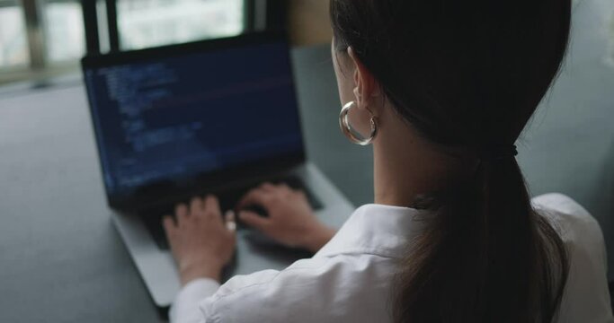 Close-up web developer of screen where visible programming code for clients. Woman hands coding on screen or web developer coding html and programming on screen laptop. Web developer at office