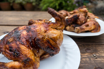 Lechon Manok, or roasted chicken served both whole and chopped outside at a bench and served with gravy.