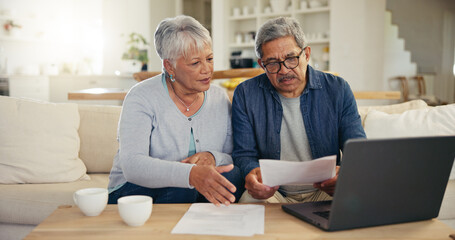 Elderly, couple and documents for financial planning in home with laptop, internet and reading for...