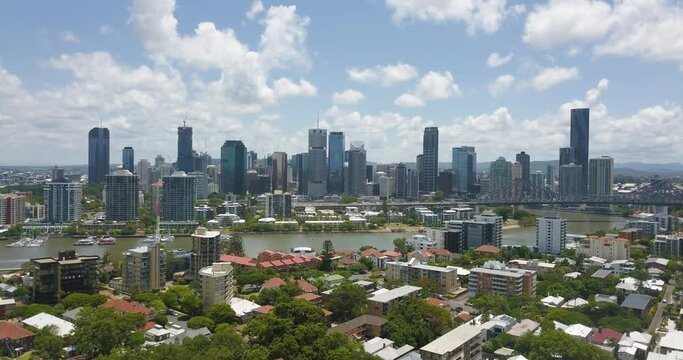 Panoramic aerial establishing overview of Brisbane Skyline and suburb with river
