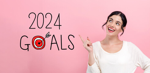 2024 goals concept with happy young woman pointing