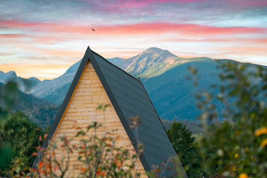 House roof against sunset in the mountains