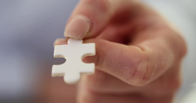 Hand holds one piece of puzzle concept