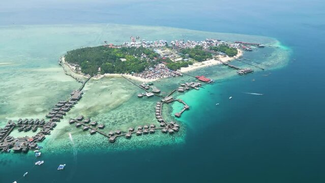 Aerial of Sabah's Mabul Island, captivating scenery of the Bajau community and the Water Village Resort, presenting a dynamic tapestry of life in this coastal haven of Malaysia.