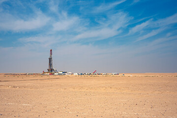 Onshore Oil Drilling Rig, in desert area. Industrial Marvel in Offshore Energy Exploration and Petroleum Production. Oil drilling and work over rig in desert isolated. - obrazy, fototapety, plakaty