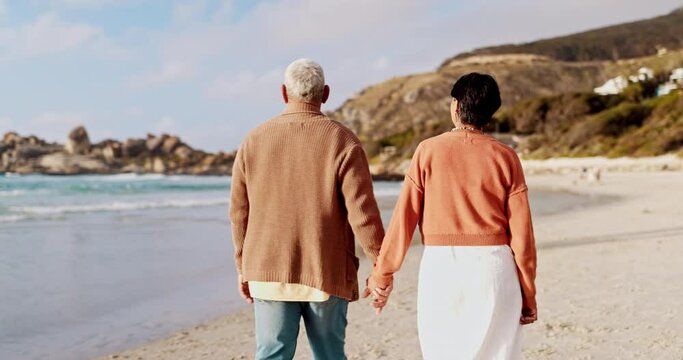 Beach, back and senior couple holding hands, walking and hand pointing to ocean, view or nature. Travel, freedom and behind elderly people at the sea for adventure, bond or romantic getaway in Mexico