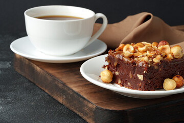 Brownie cake with chocolate and hazelnuts on plate