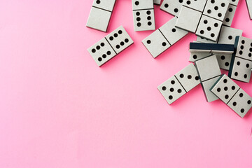 Domino tiles on pink background studio shot