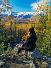 A girl on the background of an autumn Arctic landscape in the Khibiny mountains. Kirovsk, Kola...