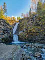 A beautiful waterfall in the autumn mountains beyond the Arctic Circle in the north, in Khibiny,...