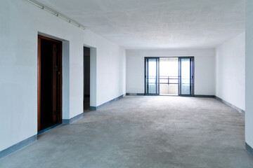 Room with white walls and cement floor
