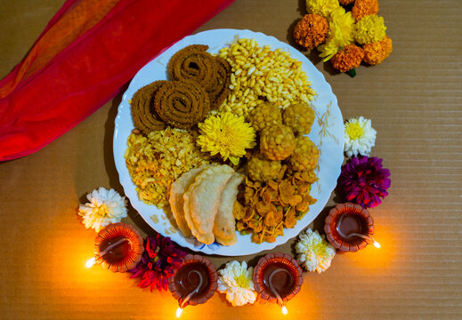 diwali snacks or diwali faral chakli, chiwda, and ladoo decorated in plate  for Diwali festival 