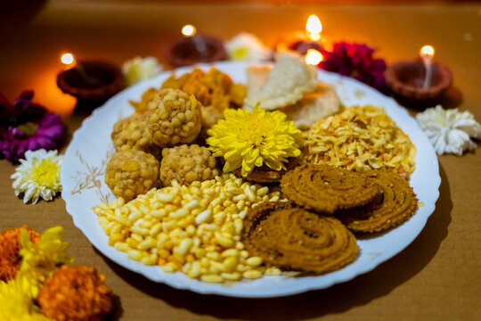 diwali snacks or diwali faral chakli, chiwda, and ladoo decorated in plate  for Diwali festival 