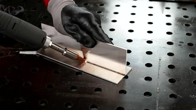 metalworking in workshop of industry plants, closeup view of worker hands, performing metalwork
