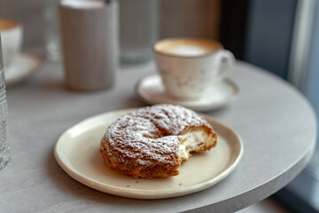Fototapeta na wymiar Curd ring with powdered sugar. Delicious breakfast with coffee
