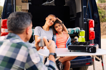 family camping in the countryside with their camper van, concept of active tourism in nature and...
