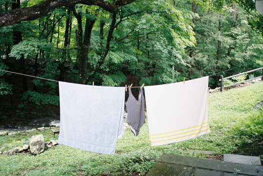 Vintage-style 35mm film photo of laundry and beachwear drying on