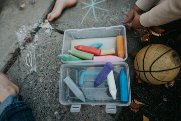 Kids draw colorful chalk art outdoors