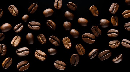 Roasted coffee beans in the air on a black background