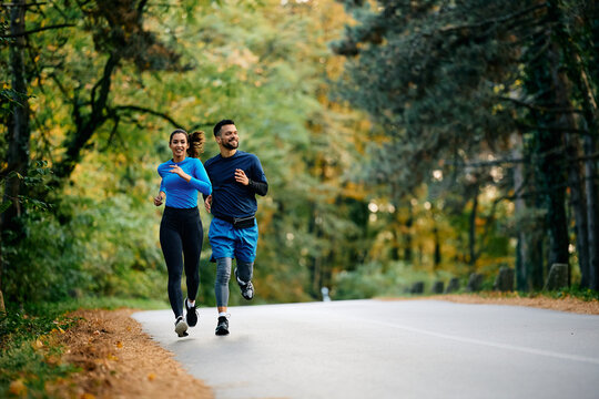 Young athletes running on road in nature.