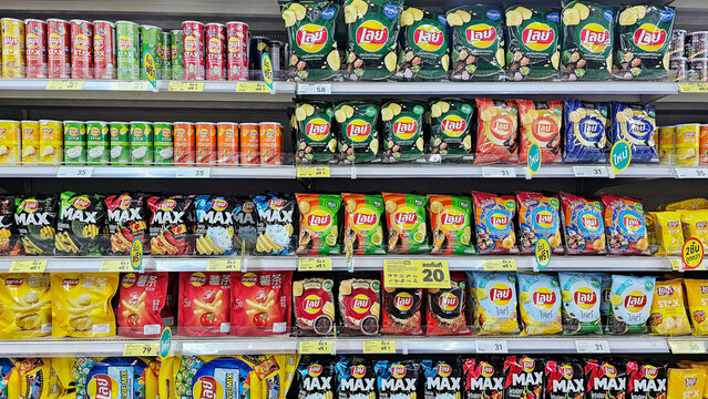 Various Potato Chip Flavours in Thailand on market shelves. Window display of Lay's Potato Chip snacks in supermarket. Thailand, November 15, 2023