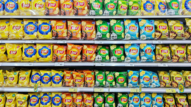Various Potato Chip Flavours in Thailand on market shelves. Window display of Lay's Potato Chip snacks in supermarket. Thailand, November 15, 2023