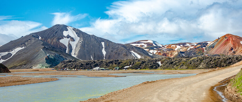 Landmannalaugar, Iceland. Panoramic View at camping site and mountain hut and huge lava field and floods, Icelandic landscape of colorful rainbow volcanic mountains at Laugavegur hiking trail