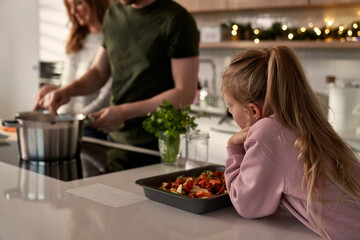 Caucasian family of four cooking before Christmas