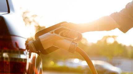 Woman hand charging the car