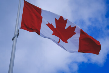 The famous Canadian flag flying in the sky of Sulphur Mountain at an altitude of more than 2400 meters. Alberta, Canada