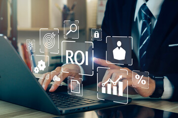 ROI,Return On Investment concept.Businessman using laptop to analysis performance measure from cost and profit efficiency.Financial growth concept.