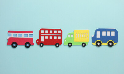 Toy buses and Truck made of felt on blue background.