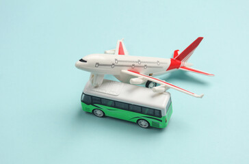 Toy bus miniature and air plane on a blue background.Travel concept