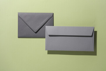 Floating envelopes on green background with shadow. Minimalism, modern business still life, creative layout