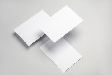 Floating blank white cards on gray background with shadow. Minimalism, modern business still life, creative layout