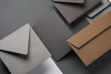 Floating envelopes and cards on dark gray background with shadow. Minimalism, modern business still life, creative layout