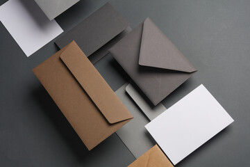 Floating envelopes and cards on dark gray background with shadow. Minimalism, modern business still life, creative layout