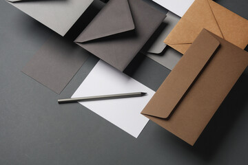 Floating envelopes and cards on dark gray background with shadow. Minimalism, modern business still life, creative layout