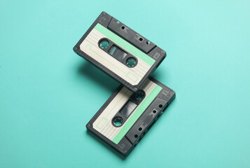 Floating retro 80s audio cassettes on a blue background. Conceptual pop, creative layout. Minimalism