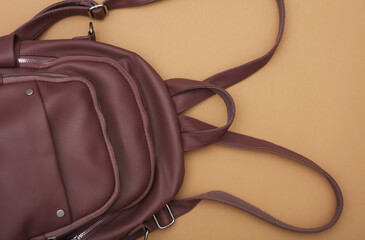 Leather backpack on brown background